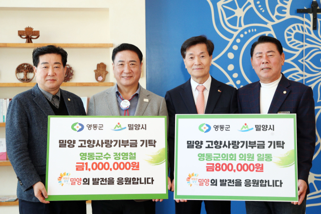 정영철 영동군수(왼쪽에서 두 번째)와 신현광 영동군의회 의장(오른쪽 첫 번째)이 밀양사랑기부금을 기탁하고 있다. 밀양시 제공
