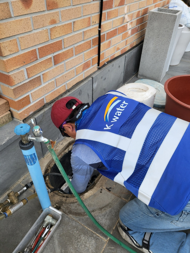 K-water 워터닥터가 현동면 가구 수도 계량기에 세척기기를 연결하고 있다. k-water 청송권지사 제공