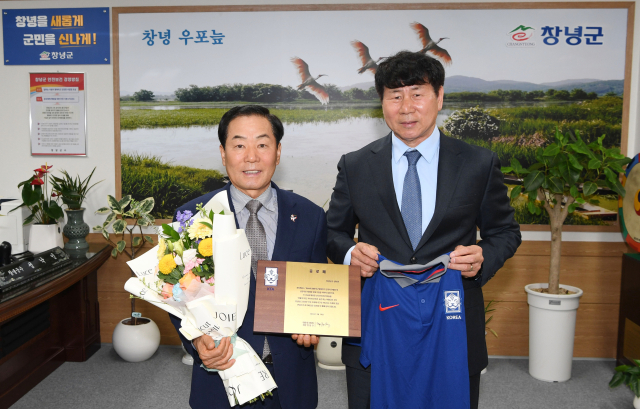 성낙인 창녕군수가 대한축구협회 관계자로부터 공로패를 수여받으며 기념촬영을 하고 있다. 창녕군 제공▷