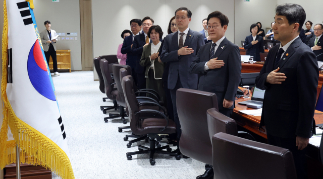 이재명 대통령이 19일 용산 대통령실에서 열린 국무회의에서 국기에 경례하고 있다. 연합뉴스