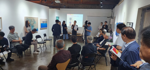 지난 20일 서울시 중구 디휘테갤러리에서 김천고 개교 100주년 기념 동문 전시회가 열렸다. 참석자들이 전시 작품에 대한 설명을 듣고 있다. /사진제공 송설당교육재단