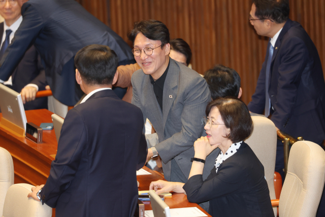 김민석 국무총리 후보자가 27일 국회 본회의장에서 의원들과 대화하고 있다. 연합뉴스