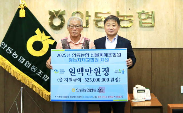 안동농협은 지난 3월 산불 피해를 입은 조합원들에게 영농자재 교환 등 5억5천300만원 규모의 지원금을 전달했다. 사진은 권태형 조합장이 조합원 권덕산(왼쪽)씨에게 100만원 교환권을 전달하는 모습. 안동농협 제공