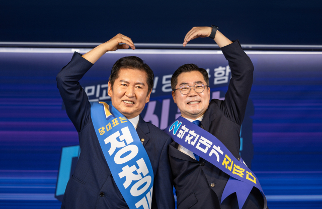 더불어민주당 대표 선거에 출마한 정청래(왼쪽), 박찬대 후보가 지난 19일 서울 여의도 당사에서 열린 합동연설회에서 함께 손하트를 만들고 있다. 연합뉴스