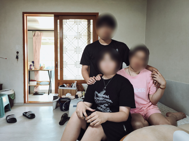 남편의 가정폭력과 의처증에 시달리며 칼부림까지 수차례 당한 뒤 최근 이혼을 한 박소피아(41·가명) 씨(분홍색 옷)가 중학생 아이들과 함께 월세방에서 지내고 있다. 김지효 기자