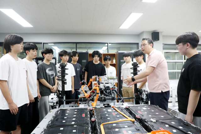 영남이공대를 방문한 고교생들에게 스마트e자동차과 류경진 교수가 전기자동차에 대해 설명하고 있다. 영남이공대 제공