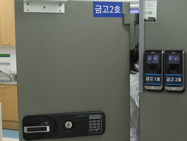 13일 계명대동산병원 약제센터에서 의료진이 마약류의약품을 꺼내고 있다. 계명대동산병원은 마약류 의약품 보관을 위해 철제금고에 사원증 카드를 찍은 뒤 열쇠를 이용해 여는 이중잠금장치를 설치해 보관하고 있다. 모든 의료기관에서는 마약류 의약품을 보관할 때는 이중잠금장치가 설치된 보관장치를 이용하도록 규정돼 있다. 이화섭 기자.