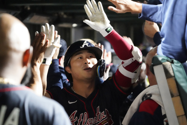Sep 3, 2025; Chicago, Illinois, USA; Atlanta Braves shortstop Ha-Seong Kim (9) is greeted in the dugout after hitting a three-run home run against the Chicago Cubs during the seventh inning at Wrigley Field. Mandatory Credit: David Banks-Imagn Images