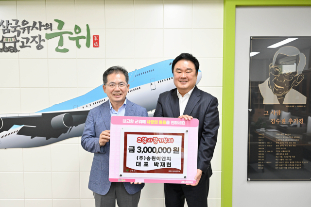 대구 달서구 송원이엔지 박재현(오른쪽) 대표가 군위군에 고향사랑기부금을 기탁하고 김진열(왼쪽) 군수와 기념 사진을 촬영하고 있다. 군위군 제공