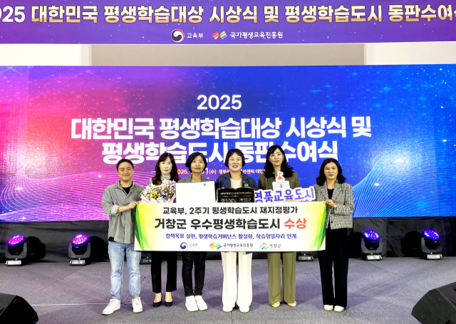 거창군 관계 공무원들이 평생학습도시 선정 기념 패 수상 후 기념사진을 촬영했다.거창군 제공
