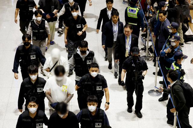 캄보디아 온라인 사기에 가담해 구금된 한국인들이 18일 오전 인천국제공항 제2터미널을 통해 송환되고 있다. 이날 송환에는 경찰 호송조 190여명이 투입됐다. 연합뉴스