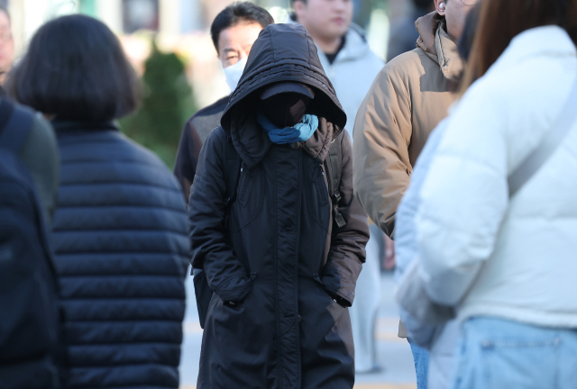 아침 기온이 전날보다 낮아져 초겨울 날씨를 보인 지난 28일 서울 종로구 광화문광장 인근 횡단보도에서 시민들이 이동하고 있다. 연합뉴스