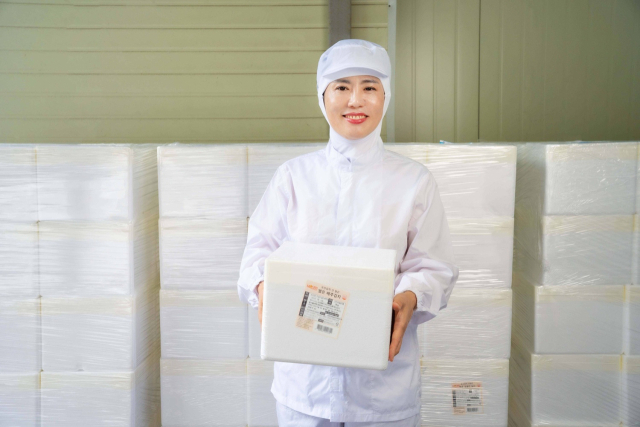 모산에프에스 김진경 대표가 갓 담근 김치 상품을 들고 있는 모습. 장성혁 기자