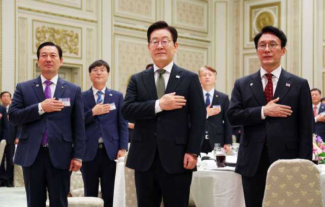 이재명 대통령이 12일 청와대 영빈관에서 열린 시장·군수·구청장 초청 국정설명회에서 국기에 경례하고 있다. 연합뉴스