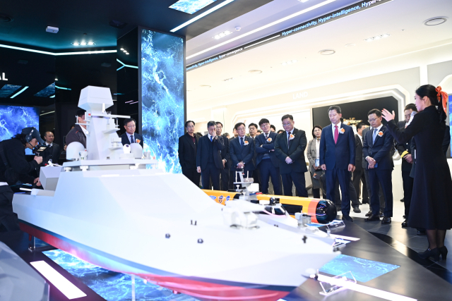 25일 한화시스템 구미사업장에 마련된 홍보관에서 주요 내빈들이 한화시스템이 개발한 무인수상정을 관람하고 있다. 구미시 제공
