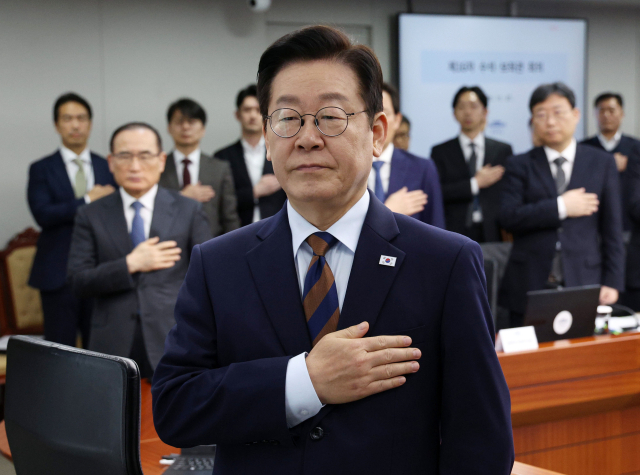 이재명 대통령이 서울 용산 대통령실에서 열린 수석보좌관회의에서 국기에 경례하고 있다. 연합뉴스