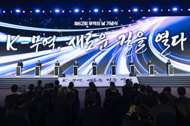 김민석 국무총리, 김정관 산업통상부 장관, 윤진식 무역협회장을 비롯한 내빈들이 4일 서울 코엑스에서 열린 제62회 무역의 날 기념식에서 세리머니를 하고 있다. 연합뉴스