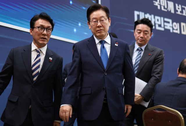 이재명 대통령이 17일 정부세종컨벤션센터에서 행정안전부(경찰청, 소방청)·인사혁신처 업무보고를 마친 후 이동하고 있다. 왼쪽부터 김민석 국무총리, 이 대통령, 강훈식 대통령비서실장. 연합뉴스