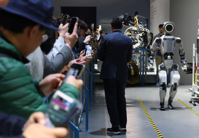 CES 개막 이틀째인 7일(현지시간) 미국 네바다주 라스베이거스 컨벤션센터(LVCC) 현대자동차 부스에서 관람객들이 로봇 아틀라스의 부품 시연을 지켜보고 있다. 연합뉴스