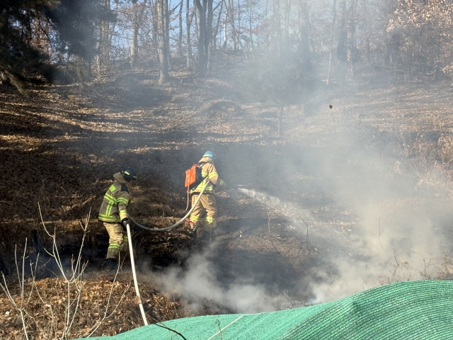 13일 오후 2시 30분쯤 대구시 군위군 효령면 한 주택 뒷편 화재 현장에서 소방대원들이 불길이 번지는 것을 막고자 진화 작업을 벌이고 있다. 대구소방안전본부 제공.