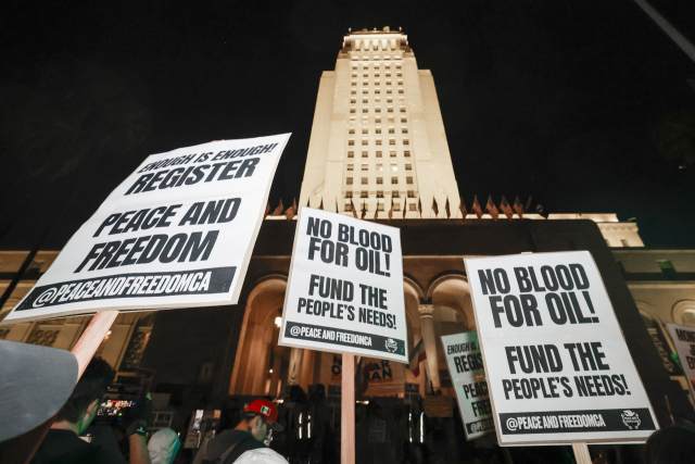 epa12791153 Demonstrators hold signs during the \
