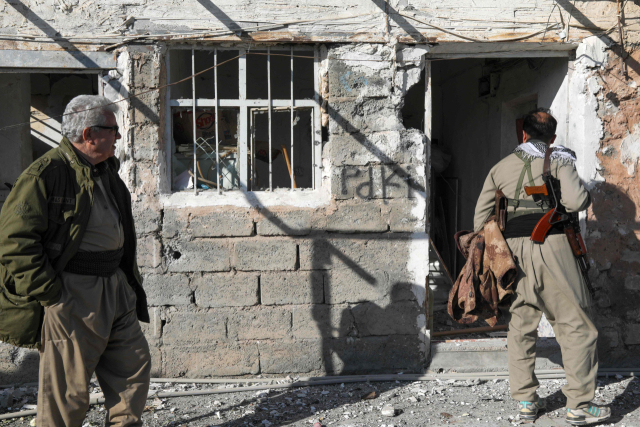 An Iranian Kurdish Peshmerga member of the Kurdistan Democratic Party of Iran (KDPI) inspects damage sustained at the Azadi Camp of the Kurdistan Democratic Party of Iran (KDPI) following an Iranian cross-border attack in the town of Koye (Koysinjaq), in the east of Erbil district in the autonomous Kurdish region of northern Iraq on March 3, 2026. The United States and Israel launched strikes against Iran on February 28, with the killing of Iran\