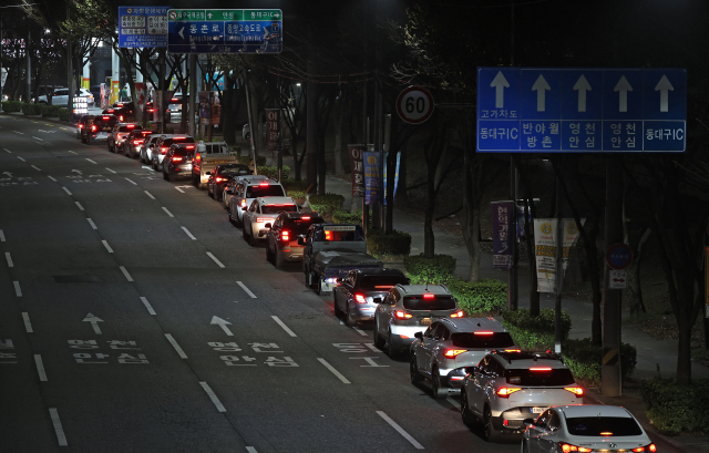28일 밤 9시 쯤 대구 동구 한 주유소 앞 도로에 기름을 넣으려는 차량들이 줄지어 서 있다. 2차 석유 최고가격제 시행에 따라 휘발유 가격이 2천 원을 곧 넘어설 거라는 전망이 나오면서 값이 오르기 전에 기름을 가득 채우려는 소비자들의 움직임이 주말 동안 이어졌다. 김영진 기자 kyjmaeil@imaeil.com
