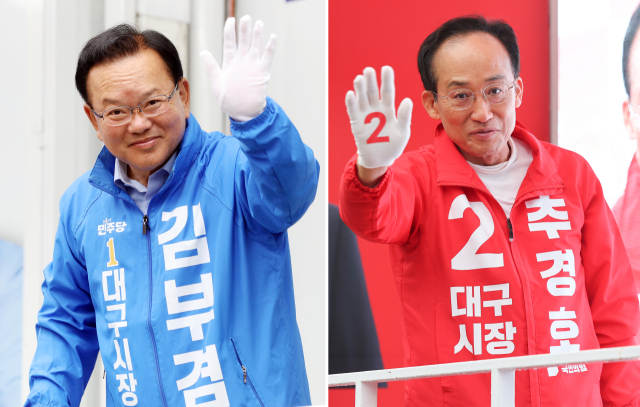 더불어민주당 김부겸 대구시장 후보(왼쪽)와 국민의힘 추경호 대구시장 후보가 21일 대구 범어네거리와 반월당사거리에서 출근길 인사를 하고 있다. 연합뉴스