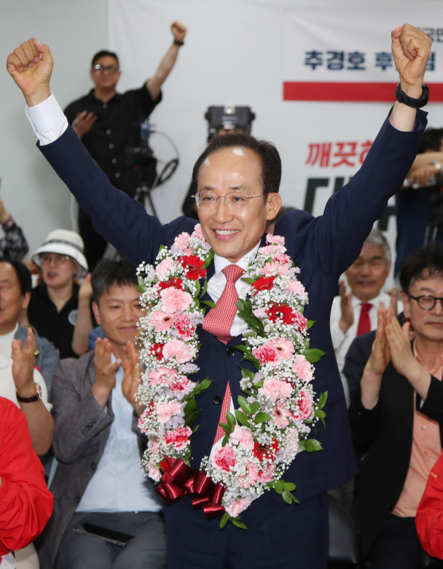 국민의힘 추경호 대구시장 후보가 당선이 유력시되면서 4일 오전 대구 범어네거리 선거사무소에서 축하 꽃다발을 목에 걸고 있다. 연합뉴스
