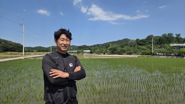 정흥국 청년농부가 모심기가 끝난 논 앞에 서 있다. 본인 제공