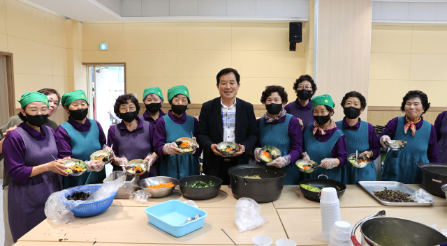 최유철 경북 의성군수가 신평면민들과 함꼐 화합의 비빔밥을 만들고 있다. 의성군 제공