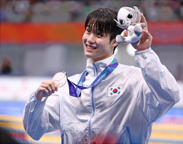 한국의 황선우가 23일 도쿄 아쿠아틱스 센터에서 열린 2026 아이치·나고야 아시안게임 수영 남자 200m 개인 자유형 결승에서 은메달을 획득, 시상식을 마친 뒤 환하게 웃으며 인사하고 있다. 연합뉴스
