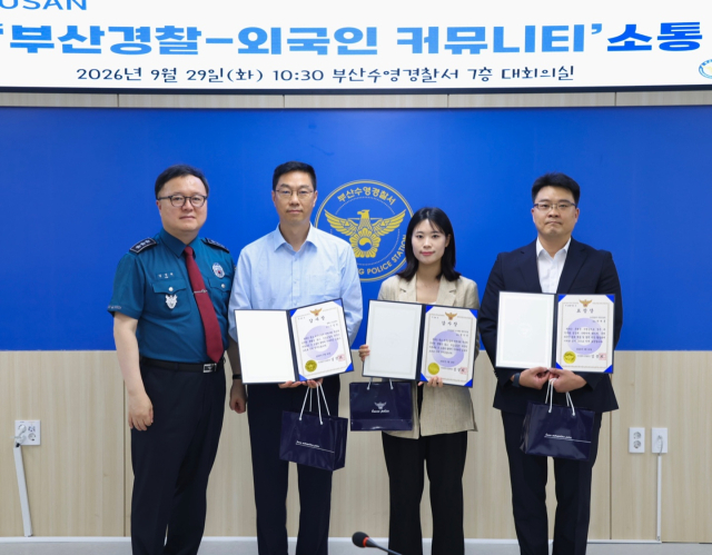 29일 부산수영경찰서에서 열린 외국인 커뮤니티 치안 간담회에서 참석자들이 표창장을 들고 기념촬영을 하고 있다. [사진=부산경찰청]