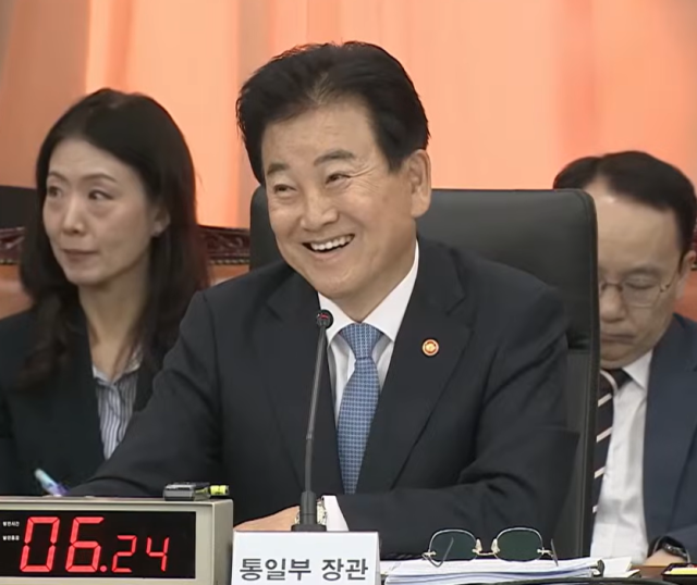 박충권 국민의힘 의원의 질의를 듣던 정동영 통일부 장관이 웃고 있다. /국회방송