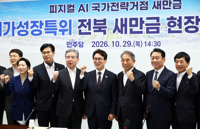 더불어민주당 김민석 대표를 비롯한 당 메가성장특위 위원과 이원택 전북도지사, 기업인들이 29일 전북 새만금에서 열린 민주당 메가성장특별위원회 현장 간담회에서 기념촬영하고 있다. 연합뉴스